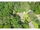 A serene aerial view of a home nestled amongst lush greenery and mature trees at 4371 N Park Dr, Tucker, GA 30084