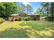 Large backyard features a deck, play area, and lush green lawn for outdoor enjoyment at 4371 N Park Dr, Tucker, GA 30084