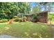 Lush backyard features a deck, play area, and plenty of green space for recreation at 4371 N Park Dr, Tucker, GA 30084