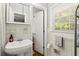 Classic bathroom with tiled walls, pedestal sink, and vintage-inspired fixtures at 4371 N Park Dr, Tucker, GA 30084