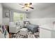 Cozy bedroom with neutral tones, wainscoting, and a comfortable reading chair at 4371 N Park Dr, Tucker, GA 30084
