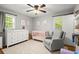 Serene Bedroom featuring a crib, glider chair, and ample natural light at 4371 N Park Dr, Tucker, GA 30084