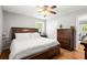 Bright bedroom with wood floors features a ceiling fan, a large bed, and lots of natural light at 4371 N Park Dr, Tucker, GA 30084