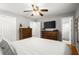 Primary bedroom featuring neutral colors, hardwood floors, and ensuite bathroom access at 4371 N Park Dr, Tucker, GA 30084