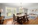 Bright dining room featuring hardwood floors, a rustic wood table, and large windows offering ample natural light at 4371 N Park Dr, Tucker, GA 30084