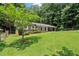 Landscaped front lawn and covered front porch of this brick home at 4371 N Park Dr, Tucker, GA 30084