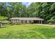 Charming brick home with well-manicured lawn and covered parking at 4371 N Park Dr, Tucker, GA 30084
