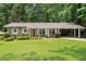 Charming brick home with well-manicured lawn and covered parking at 4371 N Park Dr, Tucker, GA 30084