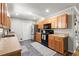Functional kitchen featuring granite counters, stainless steel appliances, tile floor, and ample cabinet space at 4371 N Park Dr, Tucker, GA 30084