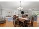 Open-concept living room with a dining area, fireplace, and a comfortable gray sofa, creating a cozy gathering space at 4371 N Park Dr, Tucker, GA 30084