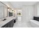 Elegant bathroom featuring a freestanding tub, modern tile, and marble countertops at 4539 Braselton Hwy, Hoschton, GA 30548