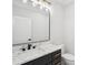 Modern bathroom featuring granite countertop vanity, black hardware, and modern mirror at 4539 Braselton Hwy, Hoschton, GA 30548