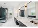 Luxurious bathroom with marble floors, double vanities, modern mirrors, and a glass-enclosed shower offers a spa-like experience at 4539 Braselton Hwy, Hoschton, GA 30548