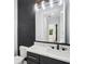 Stylish bathroom features black vanity with marble countertop and gold accents, along with a modern mirror at 4539 Braselton Hwy, Hoschton, GA 30548