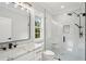 Modern bathroom featuring marble countertops, sleek black fixtures, and a glass-enclosed shower at 4539 Braselton Hwy, Hoschton, GA 30548