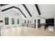 Spacious bonus room featuring high ceilings with wood beams, wood flooring, and natural light at 4539 Braselton Hwy, Hoschton, GA 30548