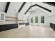 Well-lit bonus room with fireplace, wood floors, high ceilings and backyard view at 4539 Braselton Hwy, Hoschton, GA 30548