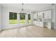 Bright eat-in kitchen area featuring a bar and floor-to-ceiling windows at 4539 Braselton Hwy, Hoschton, GA 30548