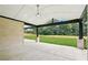 Spacious covered patio featuring a ceiling fan and a view of the well-maintained, fenced backyard at 4539 Braselton Hwy, Hoschton, GA 30548