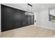 Dining room showcasing black accent wall, modern lighting and hardwood flooring at 4539 Braselton Hwy, Hoschton, GA 30548