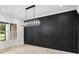 Elegant dining room boasting black accent wall, chandelier and hardwood floors at 4539 Braselton Hwy, Hoschton, GA 30548