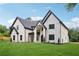 Beautiful stone and brick home featuring black-framed windows and pristine landscaping at 4539 Braselton Hwy, Hoschton, GA 30548