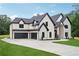 Spacious brick home featuring a three-car garage and a concrete driveway at 4539 Braselton Hwy, Hoschton, GA 30548
