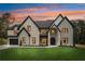 Beautiful exterior view of a two-story home, complete with a well-manicured lawn and a side-entry garage at 4539 Braselton Hwy, Hoschton, GA 30548
