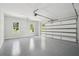 Spacious two-car garage with epoxy flooring, windows, and ample room for vehicles and storage at 4539 Braselton Hwy, Hoschton, GA 30548