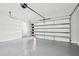 Two-car garage with epoxy flooring, modern door, and room for vehicle parking at 4539 Braselton Hwy, Hoschton, GA 30548