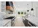 Gourmet kitchen boasts marble counters, stainless appliances, and black range hood at 4539 Braselton Hwy, Hoschton, GA 30548