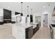 Open kitchen featuring marble island, fireplace and stainless appliances, perfect for entertaining at 4539 Braselton Hwy, Hoschton, GA 30548