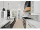Gourmet kitchen features white cabinets, marble countertops, and stainless steel appliances at 4539 Braselton Hwy, Hoschton, GA 30548