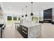 Expansive kitchen with fireplace, marble countertop island, stainless appliances, and natural light at 4539 Braselton Hwy, Hoschton, GA 30548