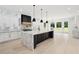 Bright, open kitchen with marble countertops, black cabinets, and a large central island at 4539 Braselton Hwy, Hoschton, GA 30548