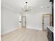 Spacious living room with wood floors, modern lighting, and large windows for natural light and a calming atmosphere at 4539 Braselton Hwy, Hoschton, GA 30548