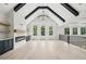 Bright living room with vaulted ceiling, exposed beams, fireplace, and large windows overlooking the backyard at 4539 Braselton Hwy, Hoschton, GA 30548