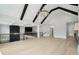 Upstairs living room featuring hardwood floors, fireplace, modern chandelier and staircase with black railing at 4539 Braselton Hwy, Hoschton, GA 30548