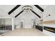 Spacious living room with fireplace, wood floors, large windows and modern chandelier at 4539 Braselton Hwy, Hoschton, GA 30548