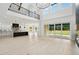 Open-concept living room featuring a modern kitchen, fireplace and hardwood floors at 4539 Braselton Hwy, Hoschton, GA 30548