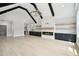 Bright living room with hardwood floors, modern fireplace, and built-in bar area, illuminated by modern lighting at 4539 Braselton Hwy, Hoschton, GA 30548