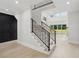 Open-concept living room boasting staircase with black railing and black accent wall at 4539 Braselton Hwy, Hoschton, GA 30548