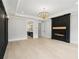 Elegant room features a fireplace, tray ceiling, and chandelier, creating a sophisticated and inviting space at 4539 Braselton Hwy, Hoschton, GA 30548