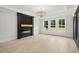 Bright living room with fireplace, large windows, and hardwood floors, offering a cozy and inviting space at 4539 Braselton Hwy, Hoschton, GA 30548
