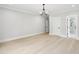 Spacious main bedroom features hardwood floors, natural light, and calming paint tones for a serene atmosphere at 4539 Braselton Hwy, Hoschton, GA 30548