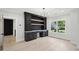 Open-concept office with sleek built-in shelving, cabinets, and drawers for seamless organization and modern lighting at 4539 Braselton Hwy, Hoschton, GA 30548