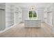 Spacious walk-in closet with custom shelving, center island, and designer lighting at 4539 Braselton Hwy, Hoschton, GA 30548