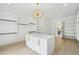 Spacious walk-in closet with custom shelving, a center island, and modern light fixture at 4539 Braselton Hwy, Hoschton, GA 30548