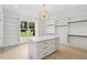 Large walk-in closet featuring custom shelves and storage, plus decorative lighting at 4539 Braselton Hwy, Hoschton, GA 30548