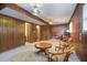 Spacious finished basement room with wood paneled walls, unique lighting, and an office space at 5152 Suggs St, Powder Springs, GA 30127